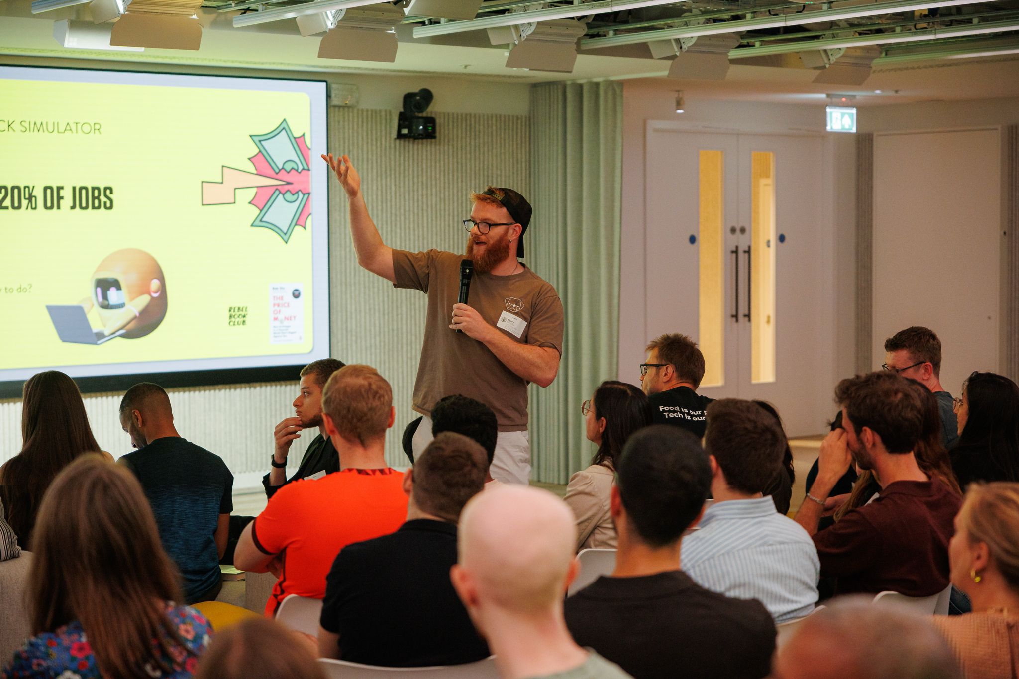 Henry presenting to an audience at Rebel Book Club